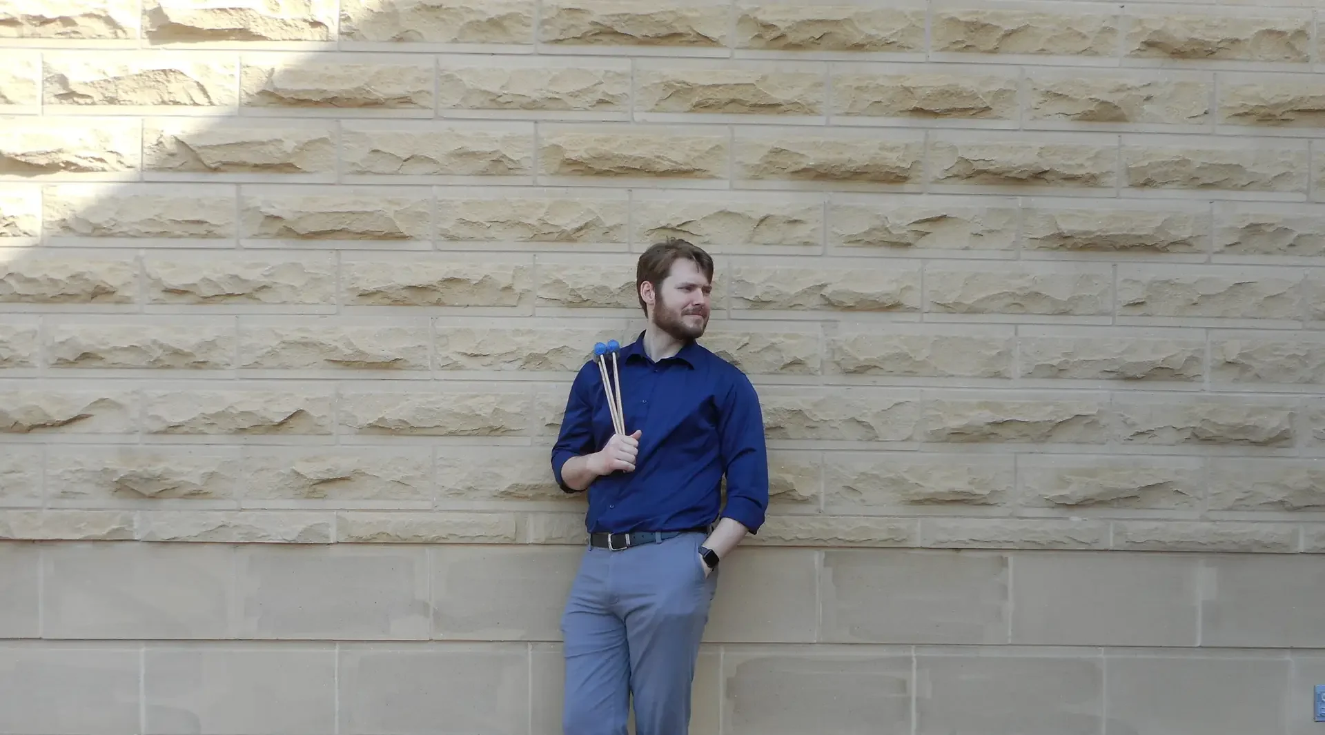 Logan Gordy Percussionist leaning on wall