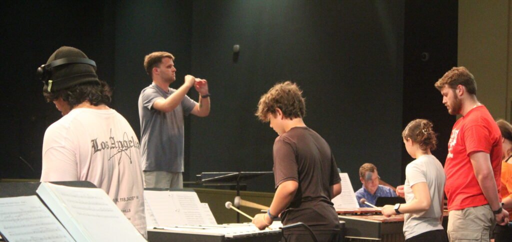 Teacher instructing music students