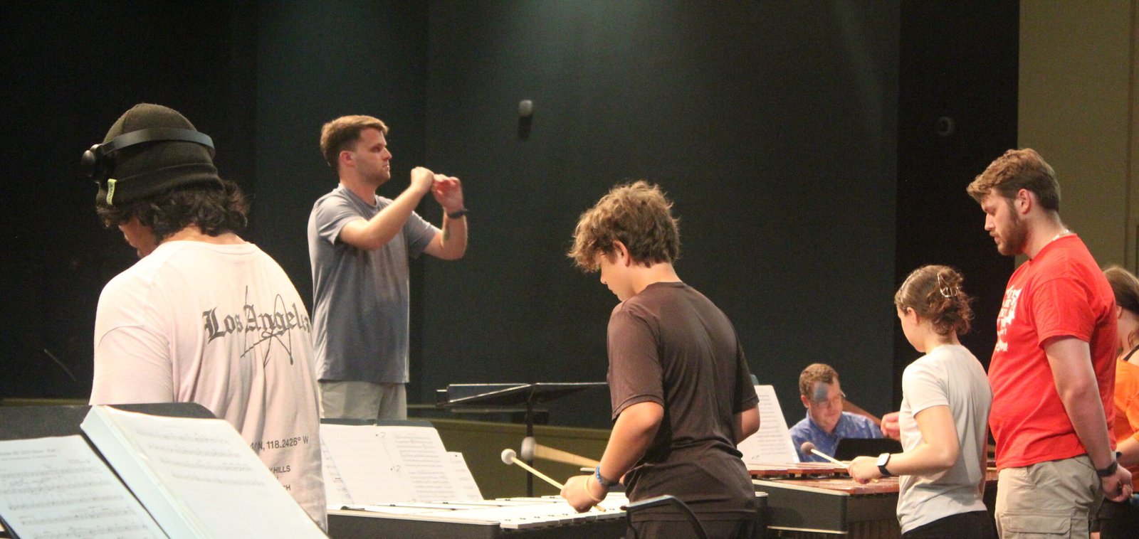 Teacher instructing music students
